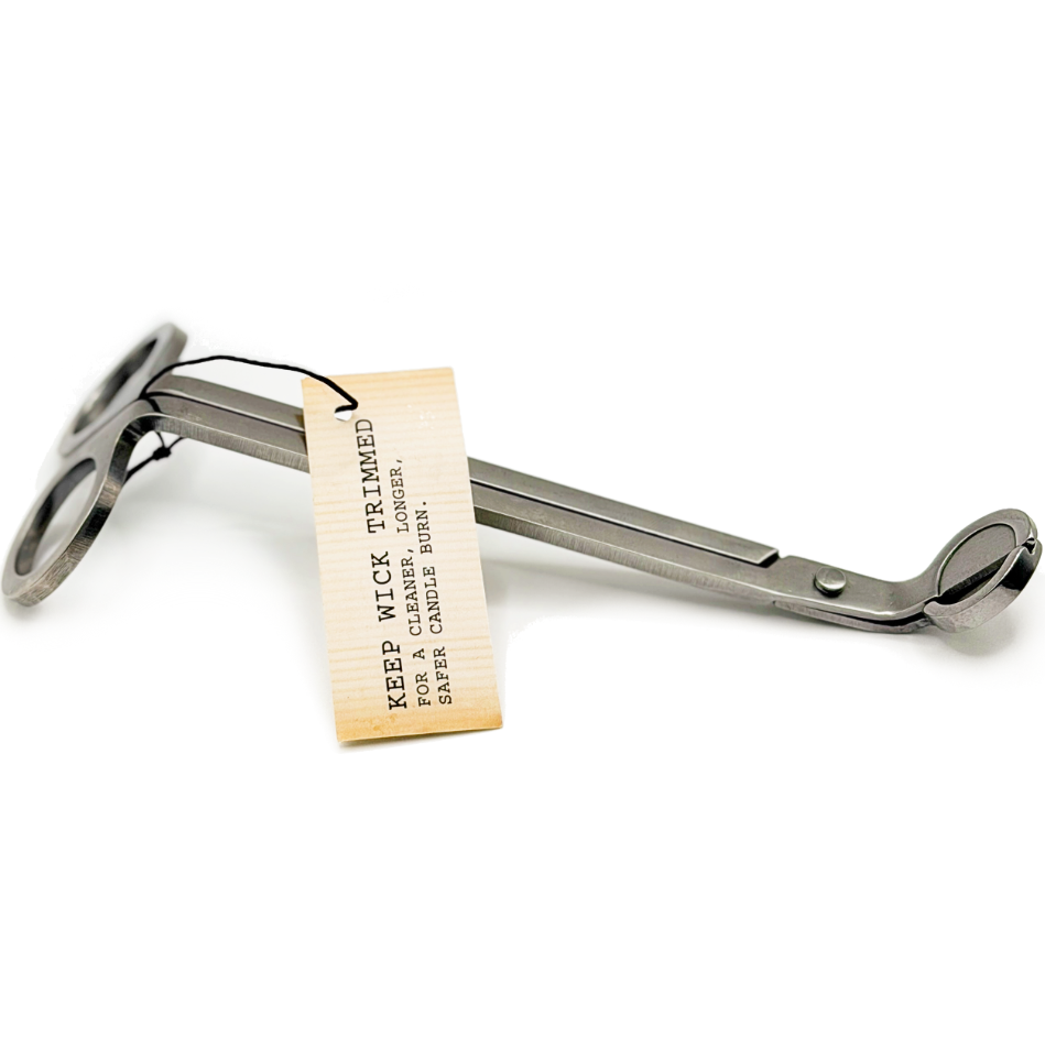 Metal candle wick trimmer with a old looking tag on a white background